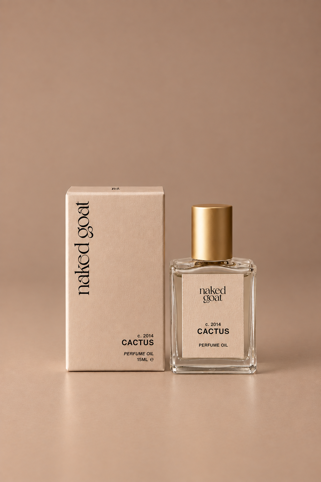 A 10ml bottle of Naked Goat Cactus Perfume Oil next to its beige cardboard packaging box, set against a warm beige background.