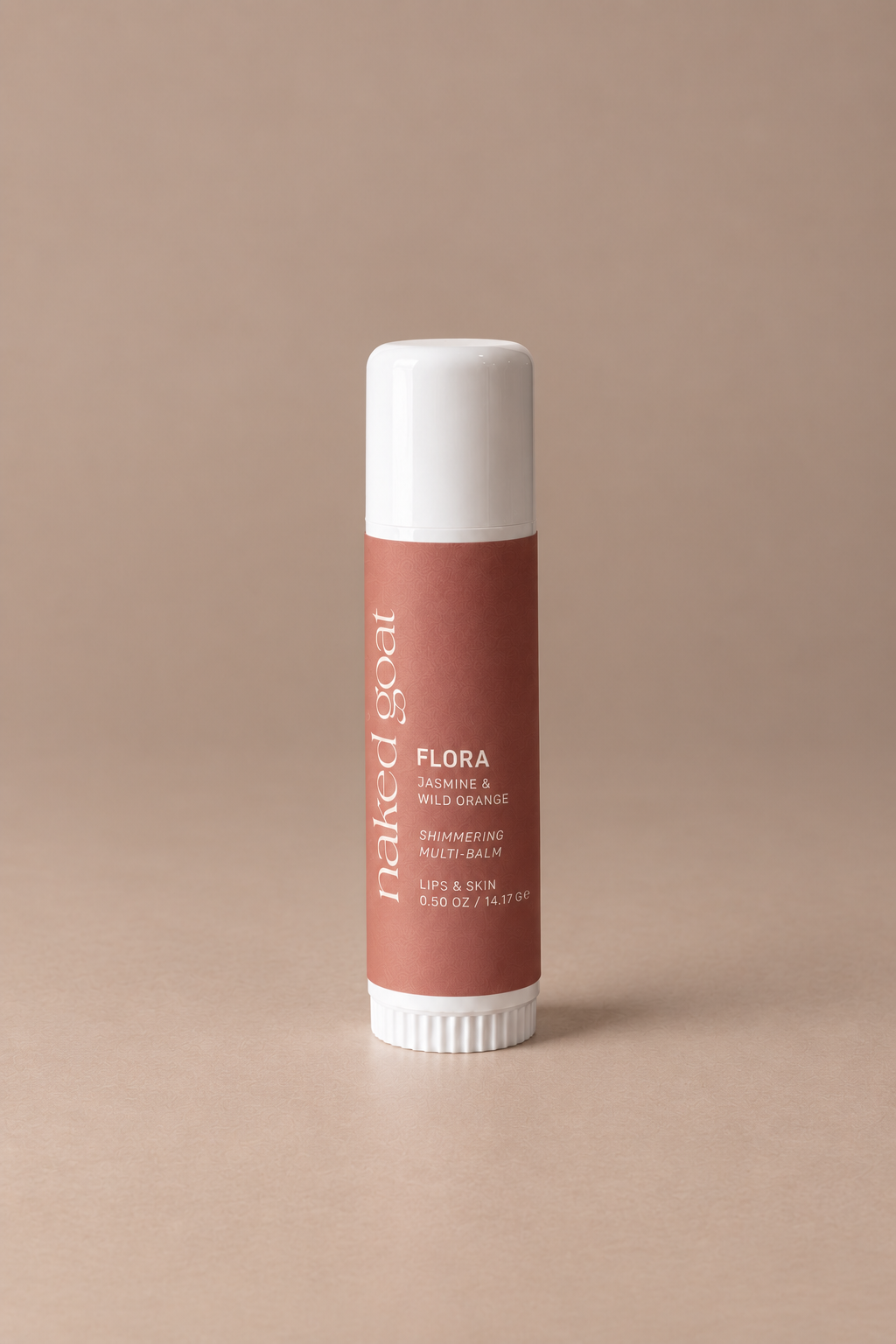 Naked Goat Flora Jasmine & Wild Orange Shimmering Multi-Balm for lips and skin on a seamless mushroom studio