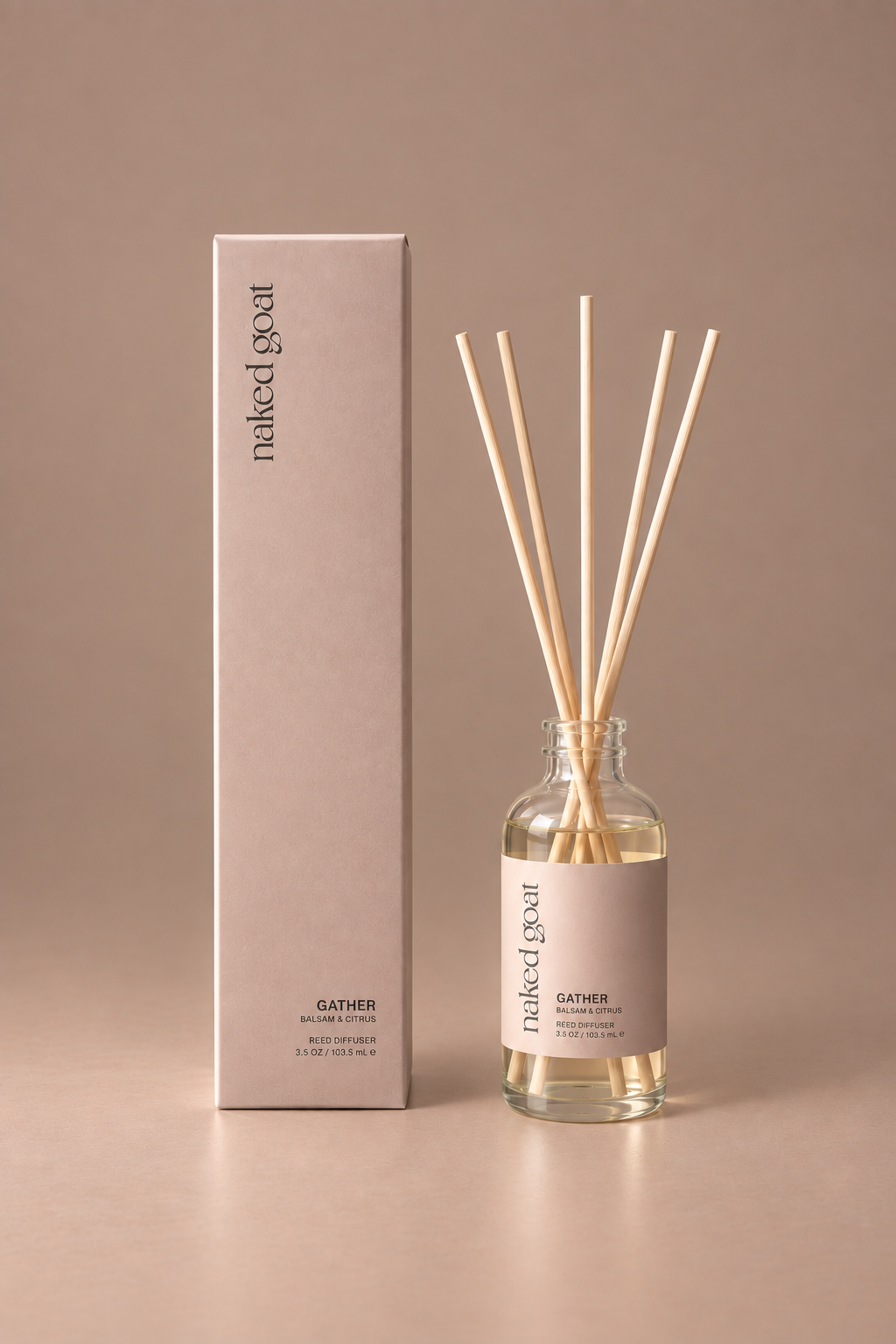 Naked Goat Gather balsam and citrus reed diffuser with matching box on a seamless mushroom studio background.