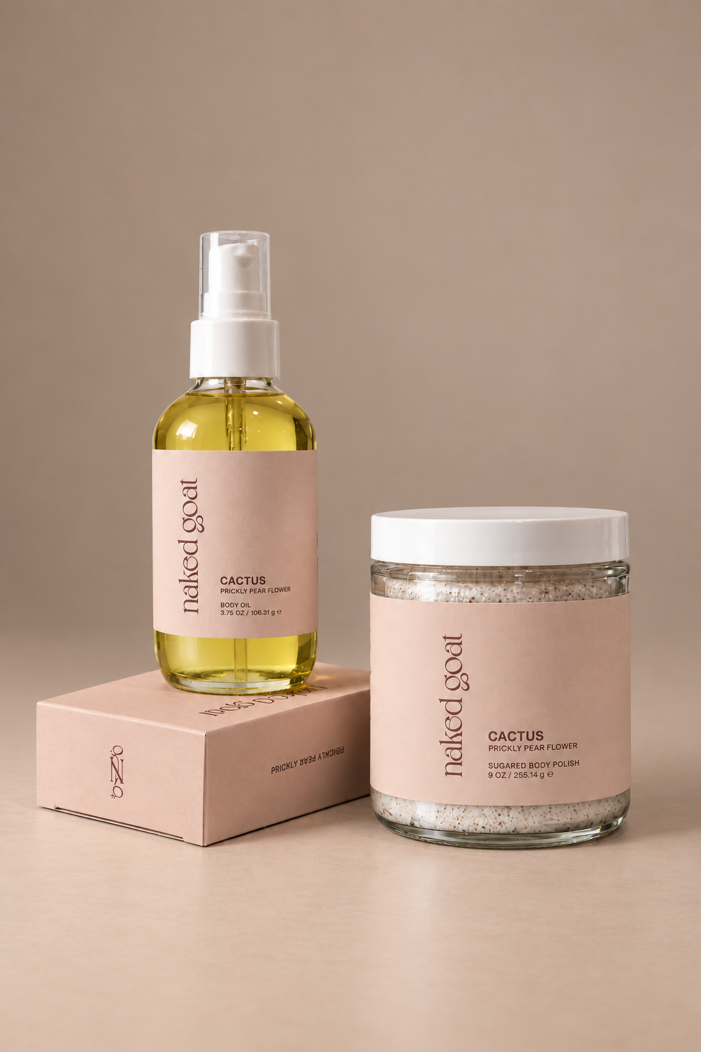 Naked Goat Cactus Prickly Pear Flower Soap Bar, Body Oil and Sugared Body Polish set on a seamless mushroom studio background.