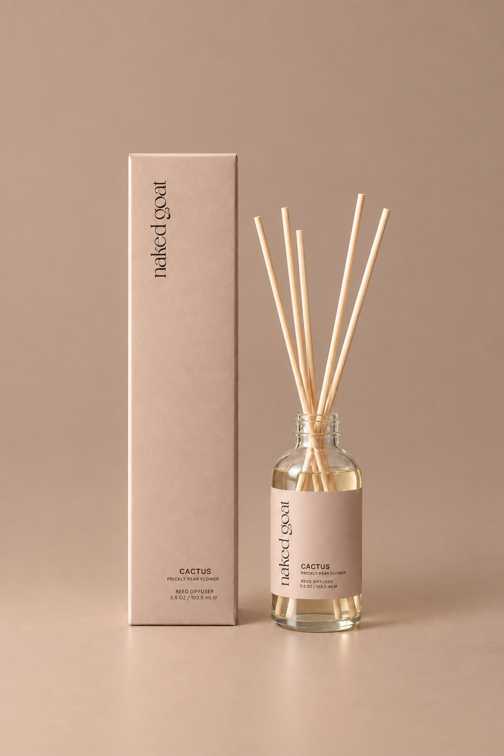 **Alt text:** Naked Goat Cactus prickly pear flower reed diffuser with matching box on a seamless mushroom studio background.