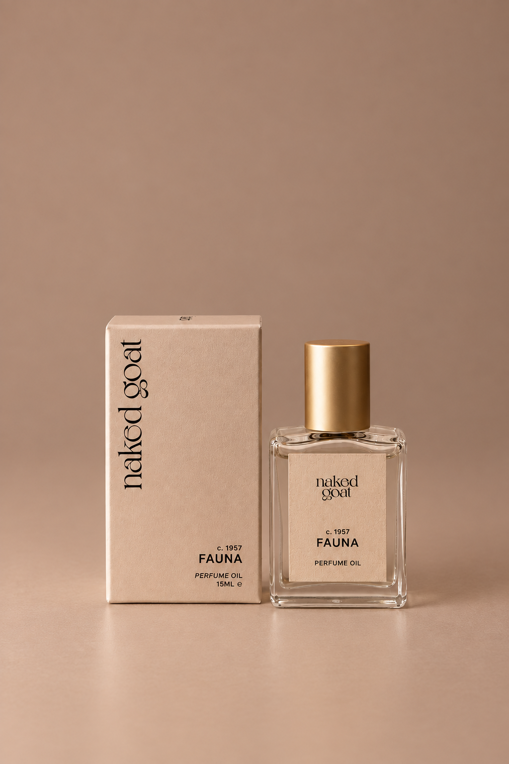 A bottle of Naked Goat Fauna perfume oil with a gold cap stands next to its beige cardboard box on a matching beige surface against a beige background.