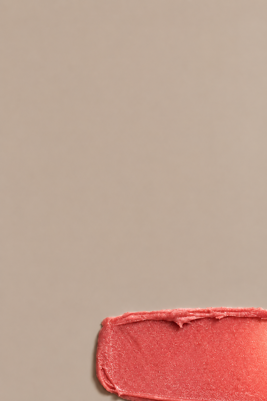 Rose tinted multi-balm texture swatch on a seamless mushroom studio background.
