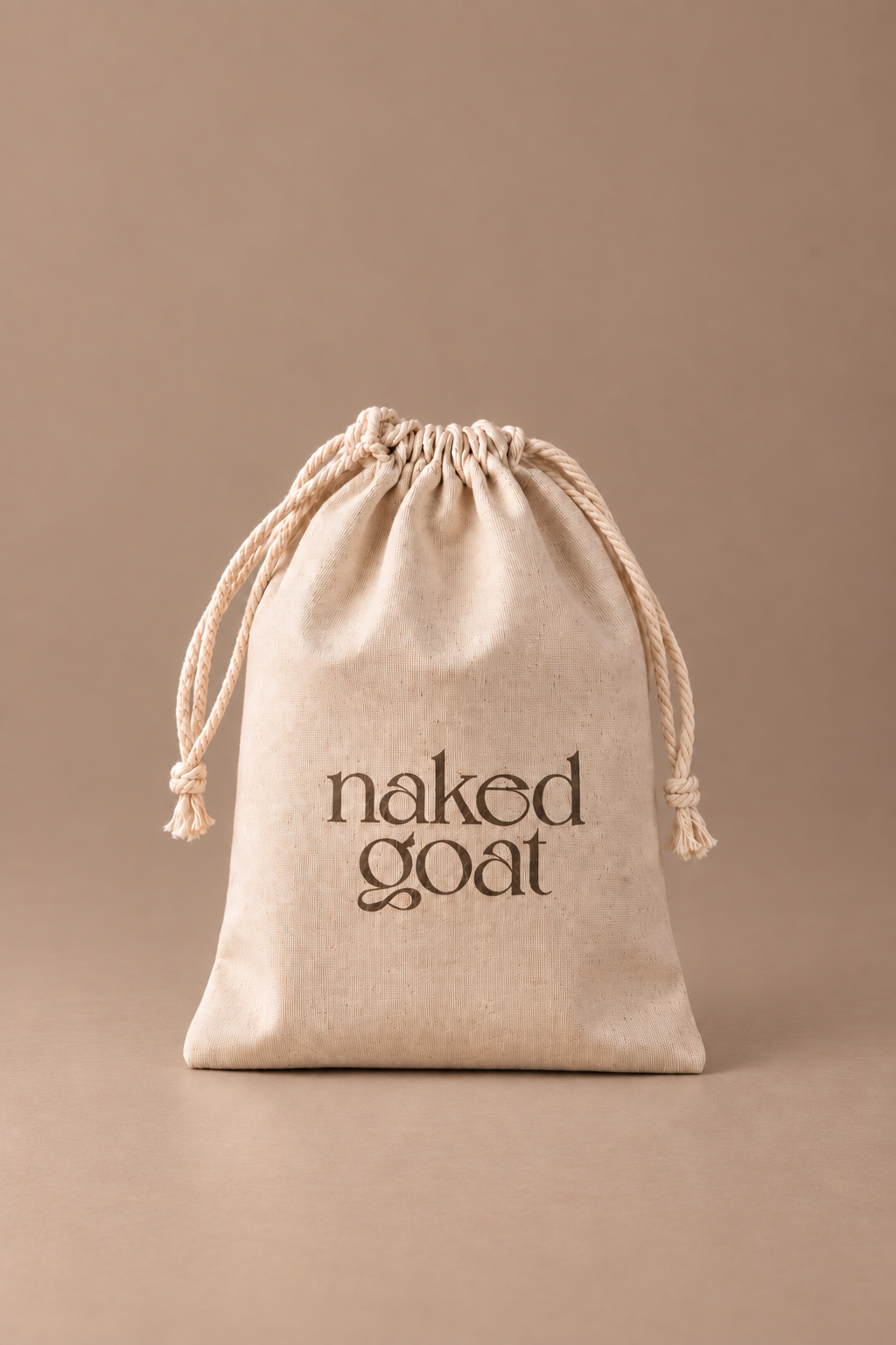 Naked Goat Perfectly Imperfect soap bars in a natural cotton drawstring bag.
